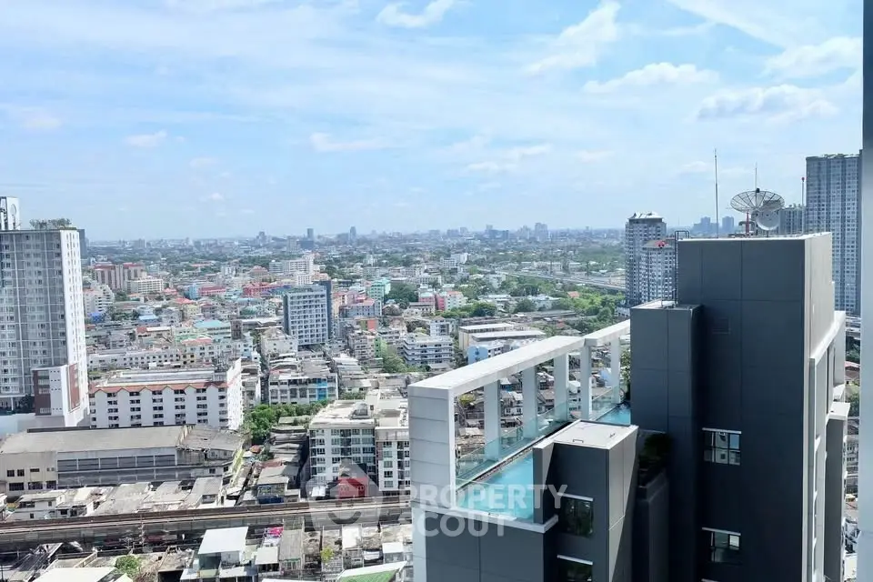 Stunning cityscape view from a modern high-rise building with rooftop pool.