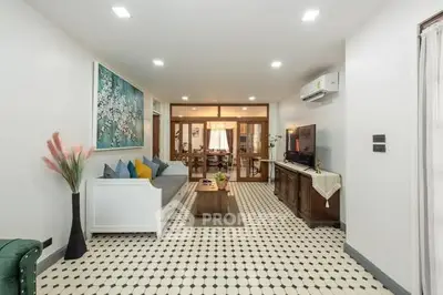 Spacious living room with modern decor and stylish furniture in a well-lit apartment.