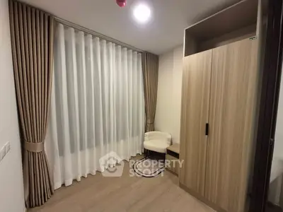 Cozy bedroom with modern wardrobe and elegant curtains in a stylish apartment.