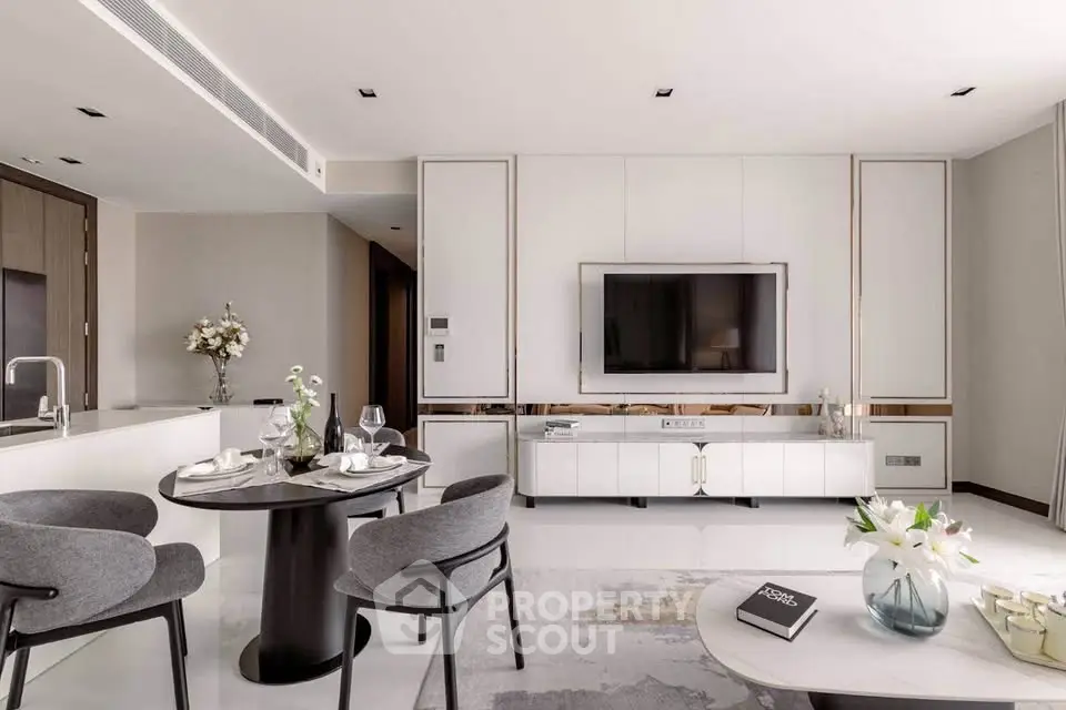 Luxurious modern living room with elegant decor and open layout, featuring a sleek TV unit and stylish dining area.