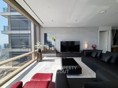Luxurious modern living room with panoramic city views and elegant furnishings.