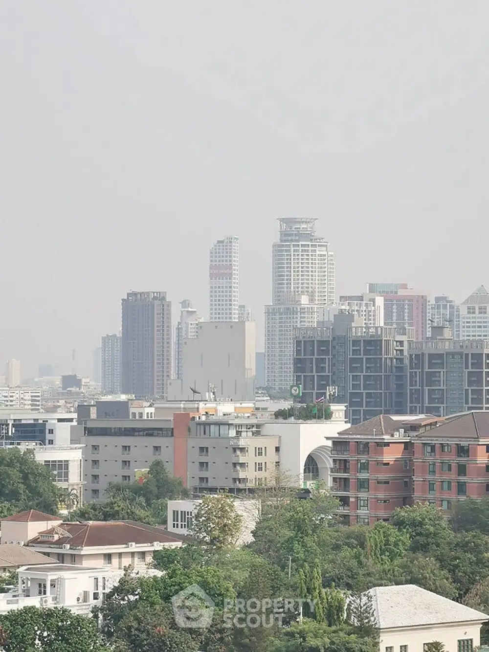 Stunning cityscape view showcasing modern high-rise buildings and lush greenery.