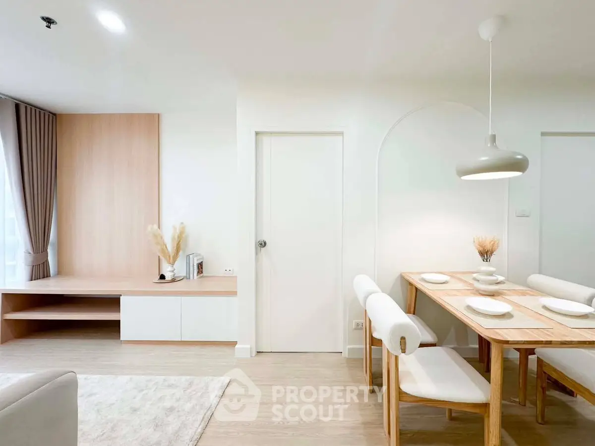 Modern dining area with elegant wooden furniture and soft lighting in a stylish apartment.