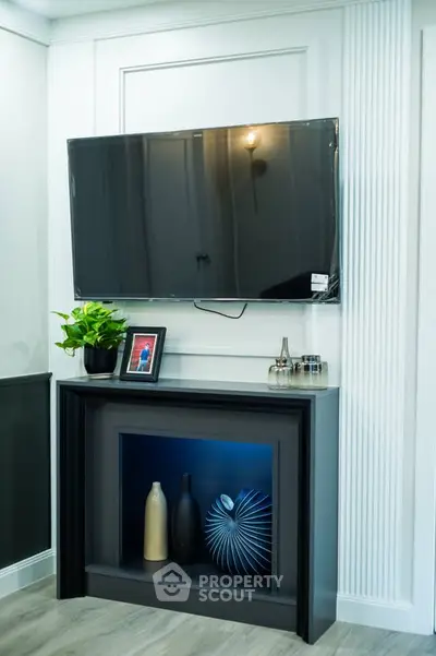 Modern living room with wall-mounted TV and stylish decor