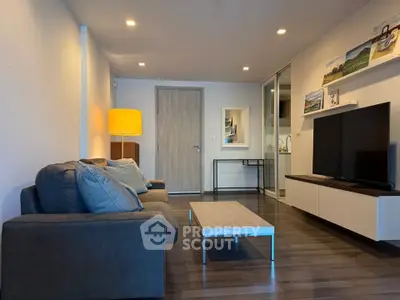 Modern living room with cozy sofa, stylish decor, and sleek TV unit in a contemporary apartment.