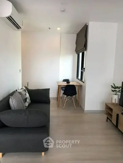 Modern living room with sleek furniture and natural light, perfect for urban living.