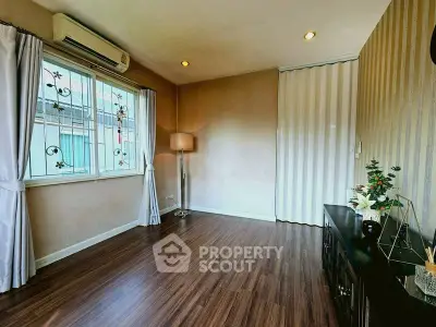 Spacious living room with elegant wooden flooring and stylish decor