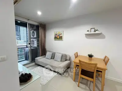 Modern living room with cozy sofa, dining table, and balcony view in urban apartment.