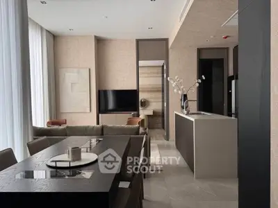 Luxurious modern living room with open kitchen, elegant dining area, and stylish decor.