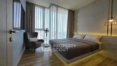 Modern bedroom with floor-to-ceiling windows and stylish decor