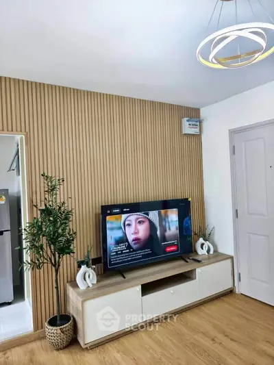 Modern living room with stylish wooden paneling and sleek TV setup