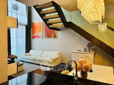 Luxurious modern living room with elegant staircase and chandelier