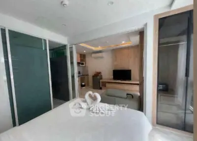 Modern studio apartment with open layout, featuring a cozy bedroom and stylish living area.