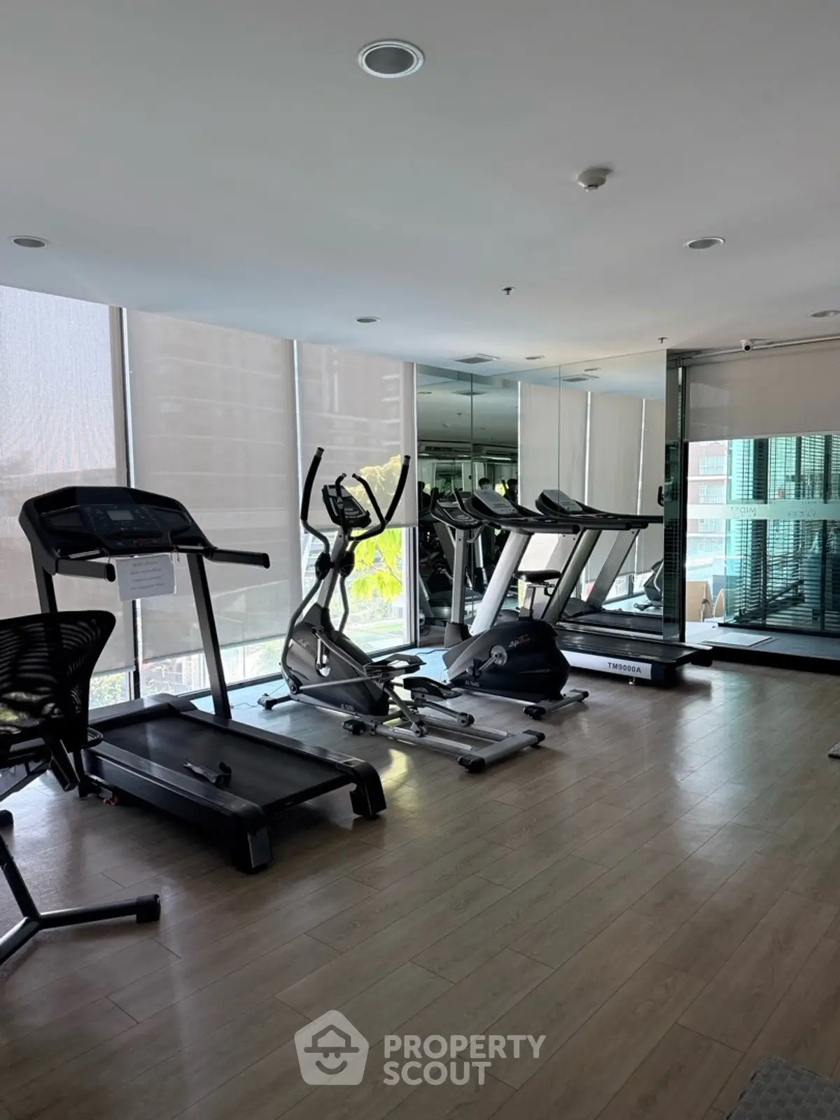 Modern gym with treadmills and exercise equipment in a high-rise building