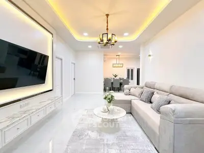 Luxurious modern living room with elegant lighting and spacious seating area.