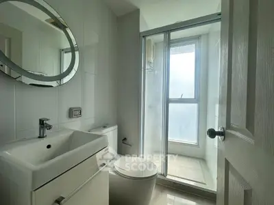 Modern bathroom with sleek fixtures and large window for natural light.