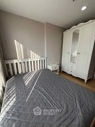 Cozy bedroom with elegant white wardrobe and natural light