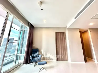 Spacious modern living room with city view and elegant chair