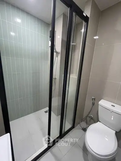 Modern bathroom with glass shower enclosure and sleek tile design