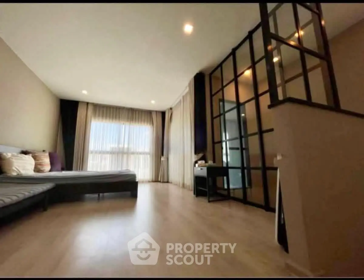 Spacious modern bedroom with large windows and stylish decor