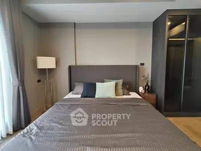 Modern bedroom with stylish decor and floor-to-ceiling window