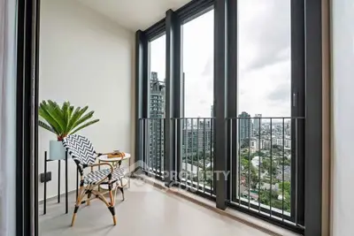 Modern balcony with stunning city view and stylish seating area.