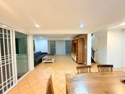 Spacious living room with modern furniture and open layout, perfect for family gatherings.