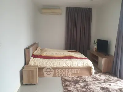 Spacious bedroom with modern furniture and natural light