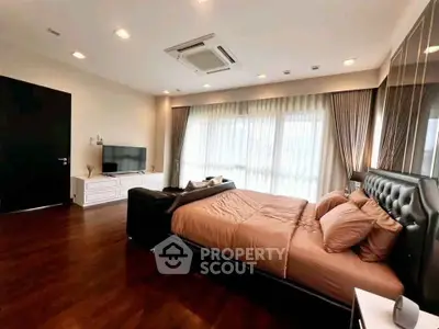 Luxurious bedroom with elegant decor and large windows for natural light.