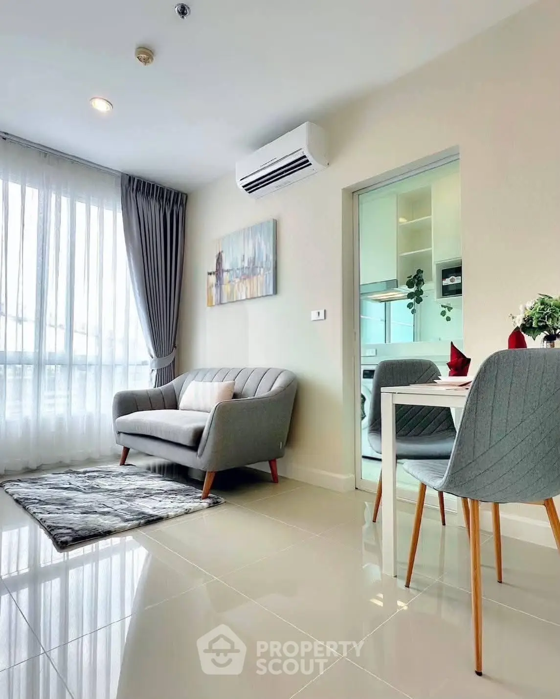 Modern living room with cozy sofa and dining area in bright apartment