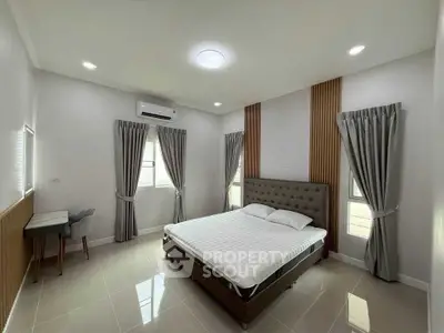 Spacious modern bedroom with elegant decor and natural light