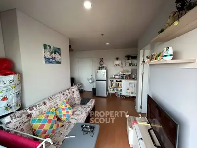 Cozy living room with colorful decor and compact kitchen in modern apartment