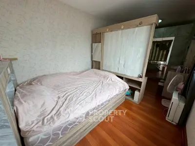 Cozy bedroom with wooden flooring and stylish partition wall