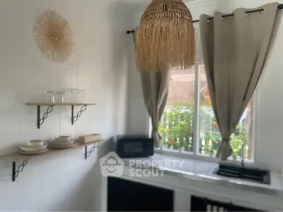 Charming kitchen with natural light, open shelves, and stylish decor