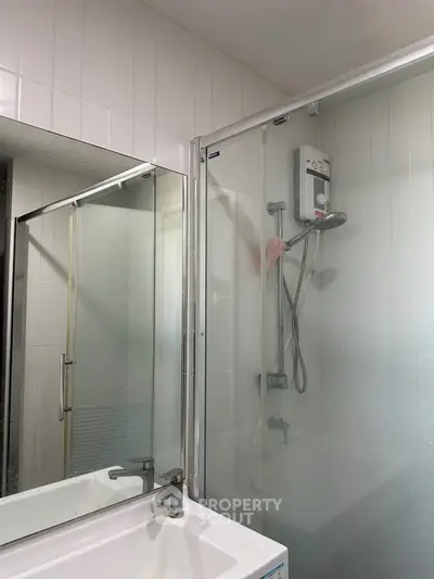 Modern bathroom with glass shower enclosure and sleek fixtures