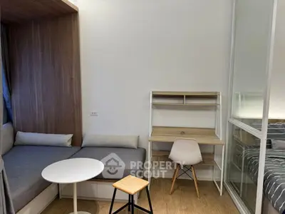Modern compact living space with cozy seating and study area