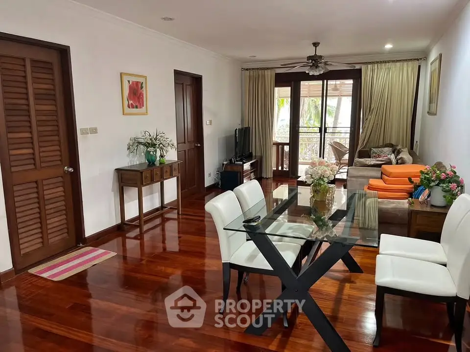 Spacious living room with elegant wooden flooring and modern decor