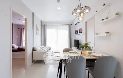 Modern open-plan living and dining area with stylish decor and natural light.