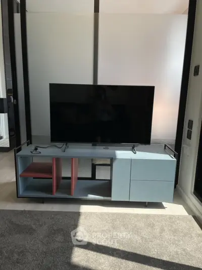 Modern living room with sleek TV stand and large flat-screen TV