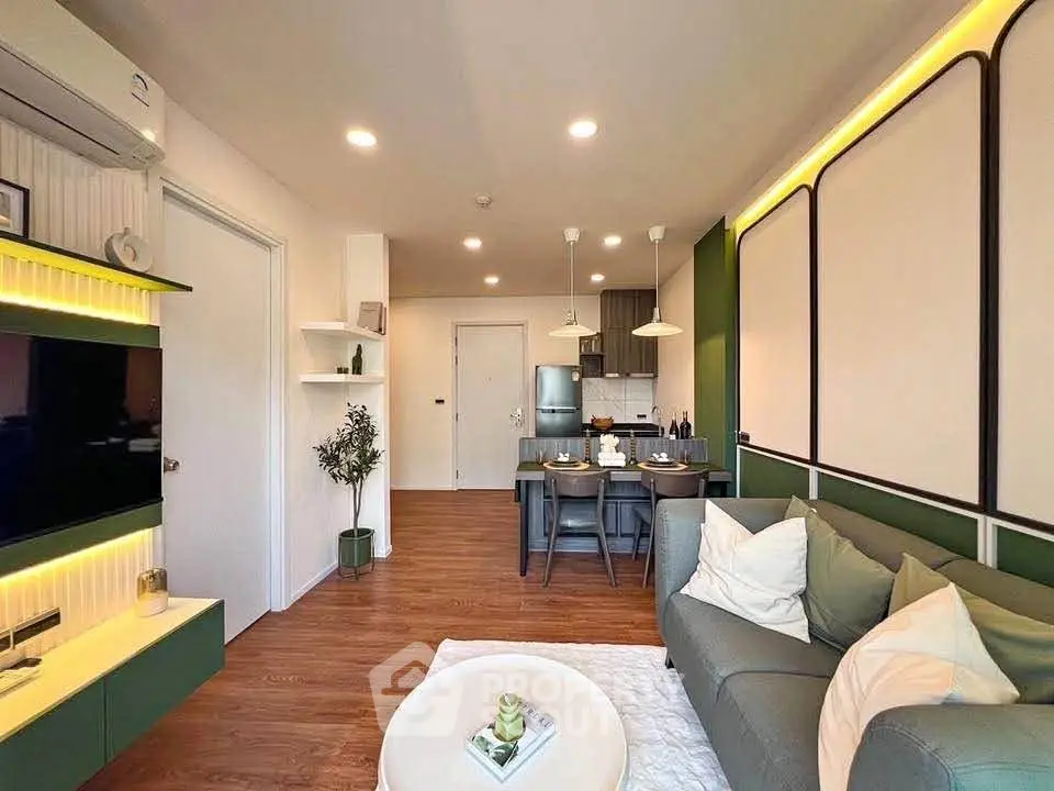 Modern living room with stylish decor and open kitchen layout, featuring cozy seating and elegant lighting.