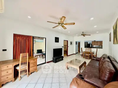 Spacious living room with leather sofa and open layout in modern apartment