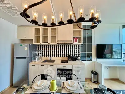 Modern kitchen with stylish chandelier, open layout, and elegant dining setup.