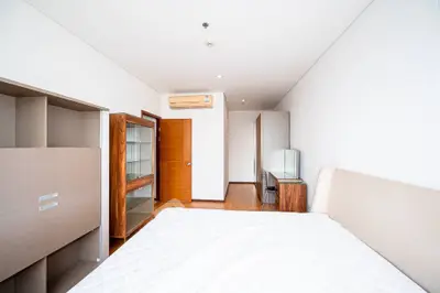 Spacious modern bedroom with minimalist design and ample natural light