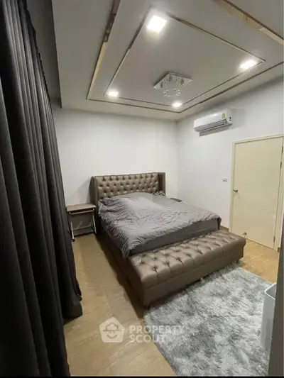 Luxurious bedroom with elegant tufted bed and modern lighting