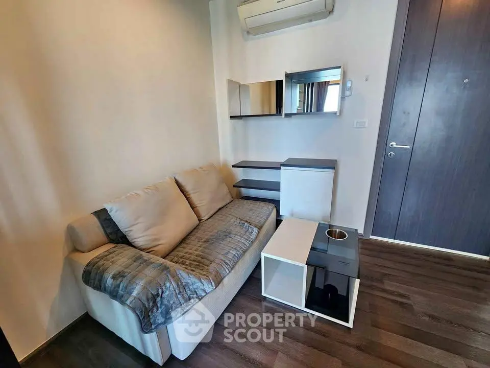 Cozy living room with modern sofa and stylish decor in a contemporary apartment.