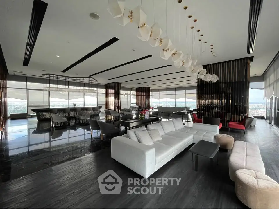 Luxurious modern living room with panoramic city views and elegant furnishings.