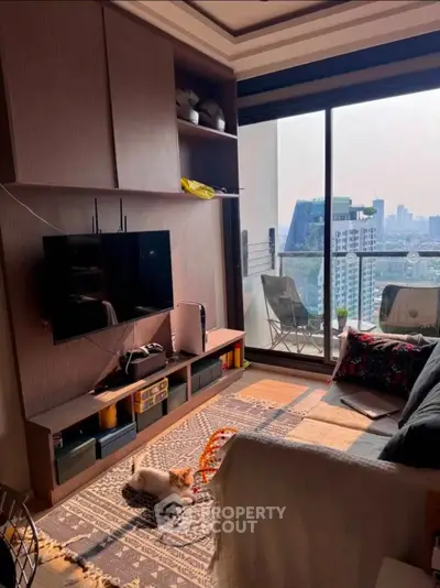 Modern living room with city view and cozy balcony, featuring stylish furniture and entertainment setup.