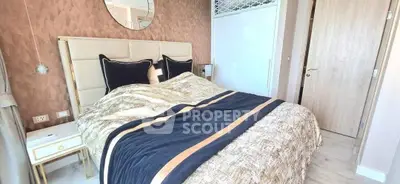 Luxurious bedroom with elegant decor and plush bedding in modern apartment.