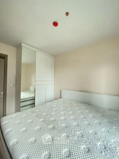Spacious bedroom with large bed and built-in wardrobe, perfect for comfort and storage.