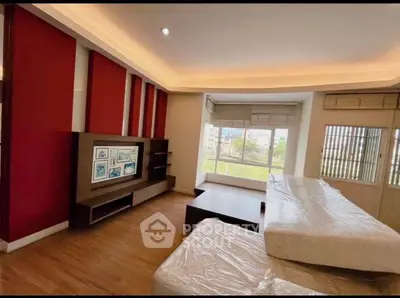 Spacious living room with modern decor and large windows offering a bright and airy atmosphere.